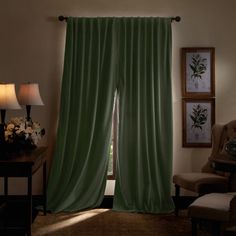 a living room scene with focus on the curtained window and chair in the foreground