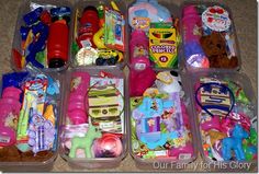 several plastic containers filled with toys on the floor