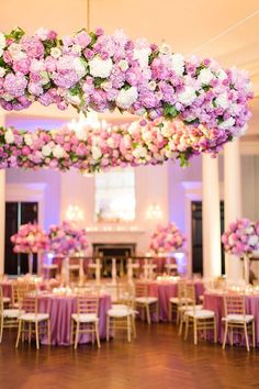 a room filled with tables covered in pink and white flowers