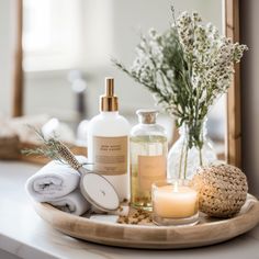 a wooden tray topped with bottles and candles