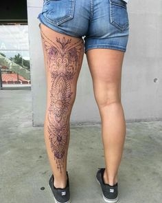 a woman's legs with tattoos on them and her butts are shown from the waist up