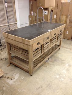 a kitchen island made out of pallet wood and metal with drawers on each side