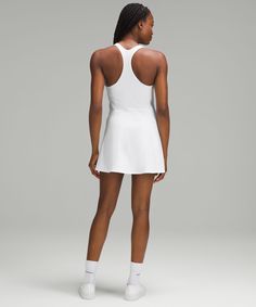 Made to move. This lightweight tennis dress gives you support and comfort to match your momentum on and off the court. For extra coverage, wear with shorts underneath. Designed for Tennis. Intended to provide medium support for B/C cups:Tight fit contours your body:Above the knee length falls to just above the centre of the kneecap:Intended for medium-impact activities. Built-in shelf bra for added support and coverage. Pockets for optional, removable cups. Racerback shape allows for full range Dress Advertisement, Lululemon Dress, Lululemon Women, Back Women, Tennis Dress, Shorts With Tights, Shelf Bra, The Court, Women Dresses