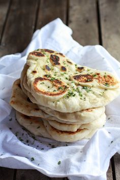 a stack of pita bread sitting on top of a white napkin