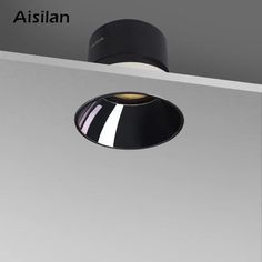 an overhead view of a black and white light fixture with the word aislan above it