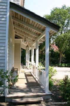 the front porch of a house with white pillars