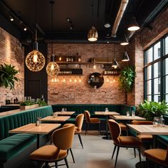 the interior of a restaurant with green velvet booths and brick walls, potted plants on either side of the tables