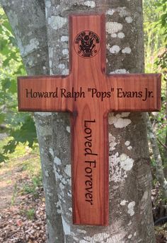 a wooden cross on the side of a tree