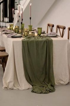 the table is set up with candles and plates for an elegant dinner or party event