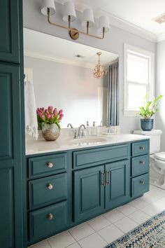 a bathroom with blue cabinets and a white toilet