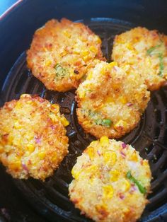 four fried food items in a frying pan