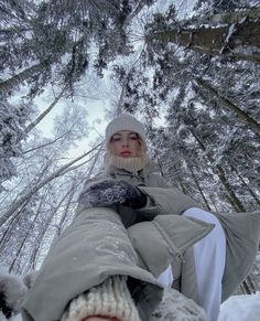 a woman sitting in the snow with her feet up