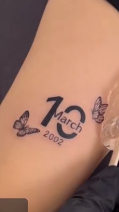 a woman's stomach with butterflies on it and the date march 2009 written in black ink