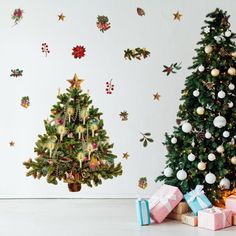 two christmas trees with presents in front of them