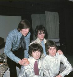 the beatles posing for a photo in their office