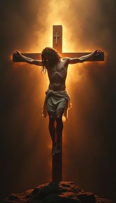 the crucifix is shown in front of a dark background with light coming from behind it