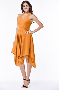 a woman in an orange dress posing for the camera with her hands on her hips