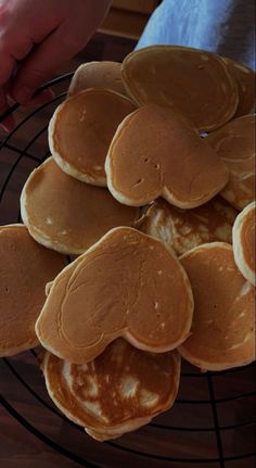 pancakes on a wire rack being held by someone's hand