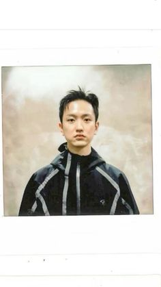 an old photo of a young man in black and white striped hoodie looking at the camera