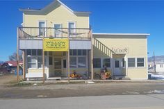 a yellow building with a sign that says willow creek