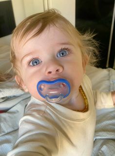 a baby with a pacifier in it's mouth