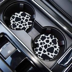 two black and white animal print cupcake pans in the center of a car