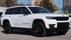 a white jeep parked in a parking lot