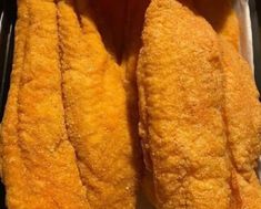 two pieces of fried food sitting in a container