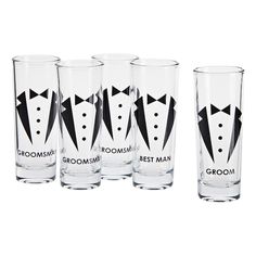 four shot glasses with black and white tuxedos on the bottom, one filled with groomsmid's best man