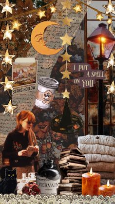 a table topped with lots of books next to a wall covered in stars and moon