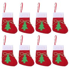 twelve christmas stockings with green and red trees on them, hanging from twine strings