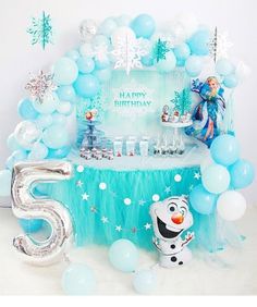 a frozen princess birthday party with balloons and decorations