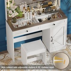 a white vanity with drawers and stools in front of blue walls, decorated with flowers