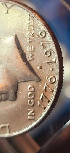 a close up of a coin with a knife sticking out of it's center