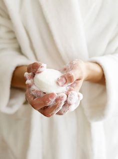 Woman in a white bathrobe washing her hands with a bar of white soap. Cheap Bed, Soap Photography, Skincare Products Photography, Conditioner Bar, Beauty Products Photography, Shampoo Bar, Beauty Essentials, Luxury Bedding, Spa Day