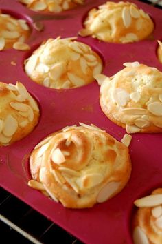 baked pastry items sitting in a muffin tin on top of a red countertop