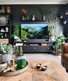 a living room filled with furniture and a flat screen tv sitting on top of a wooden table