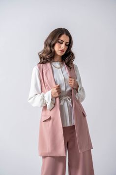 DESIGNED WITH YOU IN MIND Panama Vest from Ameera Modest Wear is practical yet beautiful. This vest will instantly transform any outfit into a refined and graceful ensemble. This women's vest features a notch lapel, a belted closure, pockets, and lined with luxe satin lining. The Panama Vest from Ameera Modest Wear is the perfect addition to your wardrobe. Specifications: Features two front pockets Entirely lined with luxe lining Includes belt Non-Stretchy material Maxi length Model is 5'11" and Chic Pink Vest For Workwear, Pink Spring Vest For Workwear, Pink Spring Vest For Work, Spring Workwear Pink Vest, Maxi Vest, Modest Wear, Women's Vest, Womens Vest, Stretchy Material