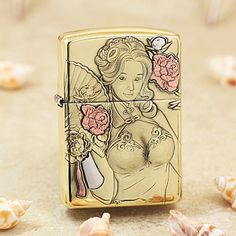 a gold zippo lighter with an image of a woman and flowers on the front