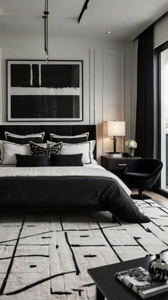 a black and white bedroom with a large bed