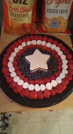 a cake made to look like the captain's shield with red, white and blue fruit