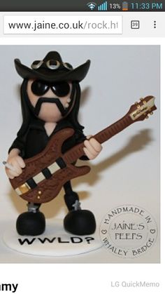 a figurine of a man with a guitar wearing a cowboy hat and sunglasses