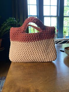 Medium sized handbag crocheted with sturdy macrame cord. This fashionable bag will fit all of your essentials- including, of course, a book and snacks. 8 inches tall and 11 wide. Burnt Umber, Rope Bag, Top Handle Bags, Macrame Cord, A Book, Purses And Handbags, Top Handle, Fashion Bags, Macrame