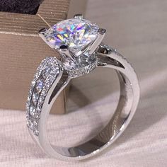 a diamond ring sitting on top of a box