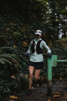 a person running on a trail in the woods