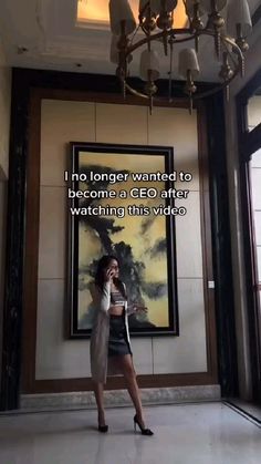 a woman standing in front of a chandelier