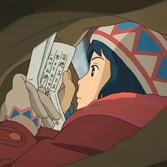 an anime character reading a book in bed