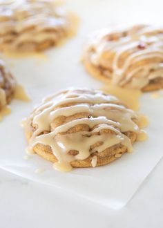 iced cookies with icing sitting on top of white paper