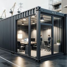 an office building made out of shipping containers with people working on computers in the room