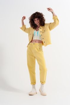 High-waisted, pleated detail at the waistband and at the cuff, are in an oh-so trendy yellow hue and in a lightweight comfy fabric.   The pockets on the side and back are functional, as are the belt loops.   These jeans look fabulous paired with a colorful bodycon or crop top or sweater and a pair of sneakers, mules, or espadrilles. We pair them with our Yellow Short Top in Batiste Fabric with Puffed Sleeves, in our photos.   The stretchy fabric is made from 94% Cotton, 5% Polyester, and 1% Elas Yellow Jeans Outfit, Double Denim Looks, Jean Mom, Yellow Denim, Jeans Look, Yellow Short, Double Denim, Slim Denim, Jeans Mom